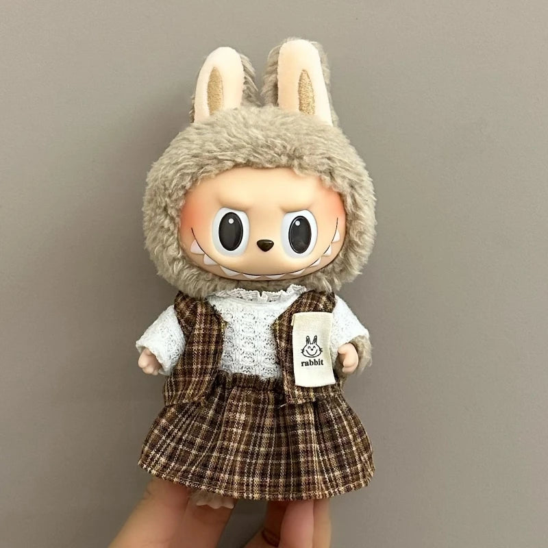 Toy figure with rabbit ears and a plaid outfit on a plain background
